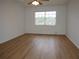 Sunny bedroom with modern floors, neutral paint, and natural light at 2297 Lark E Cir # E, Palm Harbor, FL 34684