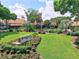 The Highland Lakes Club entrance features a well manicured lawn and inviting entrance at 2297 Lark E Cir # E, Palm Harbor, FL 34684