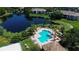 Aerial view of community pool and lake, showcasing the lush landscaping and serene setting at 10265 Gandy N Blvd # 1203, St Petersburg, FL 33702