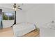 Bright bedroom features a window, ceiling fan, and hardwood floors at 10265 Gandy N Blvd # 1203, St Petersburg, FL 33702