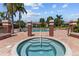 Relax in the community hot tub with tiered seating, accompanied by palm trees and comfortable lounge chairs at 10265 Gandy N Blvd # 1203, St Petersburg, FL 33702