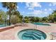 Luxurious hot tub and pool area, set amongst lush tropical landscaping near a lake at 10265 Gandy N Blvd # 1203, St Petersburg, FL 33702