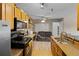 Well-lit kitchen featuring stainless steel appliances and light brown cabinetry at 10265 Gandy N Blvd # 1203, St Petersburg, FL 33702
