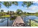 Scenic lake view with a wooden pier, lush greenery, and tranquil waters, enhancing the community's natural beauty at 10265 Gandy N Blvd # 1203, St Petersburg, FL 33702