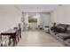 Inviting living area with updated floors, a cozy seating arrangement, and a sunlit window creating a warm atmosphere at 10265 Gandy N Blvd # 1203, St Petersburg, FL 33702