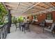 Inviting outdoor seating area with comfortable chairs and tables under a shaded pergola, perfect for relaxing at 10265 Gandy N Blvd # 1203, St Petersburg, FL 33702