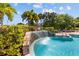 Inviting pool area with waterfall feature and lush landscaping, creating a relaxing oasis at 10265 Gandy N Blvd # 1203, St Petersburg, FL 33702
