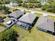 An aerial view of a house with a screened-in pool and nearby trees at 109 Beau Rivage Dr, Rotonda West, FL 33947