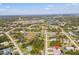 A sprawling neighborhood features well-maintained lawns, waterways, and a clear sky at 109 Beau Rivage Dr, Rotonda West, FL 33947