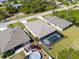 A screened-in pool and a hot tub are on the property in this aerial view at 109 Beau Rivage Dr, Rotonda West, FL 33947