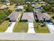 An aerial view of the house shows the well-manicured lawn and long driveway at 109 Beau Rivage Dr, Rotonda West, FL 33947