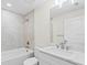 Well-lit bathroom with a tiled shower and white vanity with great lighting at 109 Beau Rivage Dr, Rotonda West, FL 33947