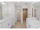 New bathroom features dual sinks with modern hardware and a tiled shower stall at 109 Beau Rivage Dr, Rotonda West, FL 33947
