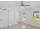 Cozy bedroom features a ceiling fan, closet, and bright windows at 109 Beau Rivage Dr, Rotonda West, FL 33947