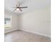 This bedroom is bright, featuring a modern ceiling fan and tile floors at 109 Beau Rivage Dr, Rotonda West, FL 33947