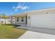 Single-story home featuring a two-car garage, covered porch, and a well-kept lawn at 109 Beau Rivage Dr, Rotonda West, FL 33947