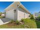 Side view of home with an attached two-car garage and manicured landscaping at 109 Beau Rivage Dr, Rotonda West, FL 33947