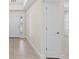 Hallway view featuring a large tile floor, neutral colors and a single white door at 109 Beau Rivage Dr, Rotonda West, FL 33947