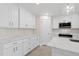 Modern kitchen features white cabinetry, granite countertops, and ample storage space at 109 Beau Rivage Dr, Rotonda West, FL 33947