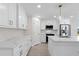Bright kitchen features white cabinets, stainless appliances, and center island with sink at 109 Beau Rivage Dr, Rotonda West, FL 33947