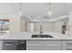 Modern kitchen features a quartz countertop island, stainless dishwasher and pendant lighting at 109 Beau Rivage Dr, Rotonda West, FL 33947