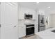 Well-equipped kitchen features stainless steel appliances and white cabinets at 109 Beau Rivage Dr, Rotonda West, FL 33947