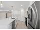 Modern kitchen features a stainless refrigerator, and an island with dishwasher and sink at 109 Beau Rivage Dr, Rotonda West, FL 33947