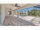 Covered patio overlooking the backyard and screened pool enclosure at 109 Beau Rivage Dr, Rotonda West, FL 33947