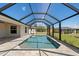Backyard pool features screened enclosure and well manicured lawn at 109 Beau Rivage Dr, Rotonda West, FL 33947