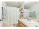 Well-lit bathroom featuring a vanity with drawers and a shower with curtains at 12960 Trade Port Pl, Riverview, FL 33579