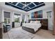 The main bedroom boasts a unique tray ceiling design, large picture window, and soft neutral tones at 14013 Kingfisher Glen Dr, Lithia, FL 33547