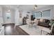 Bright living room with hardwood floors, a modern table and chairs, a sofa, and a stylish bar area at 14013 Kingfisher Glen Dr, Lithia, FL 33547