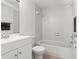 Clean bathroom with accessible handrails, tiled walls, and a modern vanity at 14211 Shadow Moss Ln # 101, Tampa, FL 33613