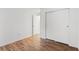 Bedroom featuring wood-look floors, ample closet space, and an open doorway to another room at 14211 Shadow Moss Ln # 101, Tampa, FL 33613