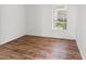 Empty bedroom offering natural light through the window and laminate wood flooring at 14211 Shadow Moss Ln # 101, Tampa, FL 33613