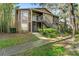Inviting two-story home with well-maintained landscaping and exterior staircase to front door at 14211 Shadow Moss Ln # 101, Tampa, FL 33613