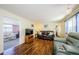 Cozy living room with hardwood floors, comfortable seating, and a television on a wooden stand at 159 Melody Ln, Tarpon Springs, FL 34689