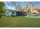 Enjoy a refreshing swimming pool, screened-in lanai and lush backyard at 1710 Orange Hill Way, Brandon, FL 33510