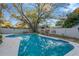 This home features a private in-ground pool with a spacious patio and mature landscaping at 1710 Orange Hill Way, Brandon, FL 33510