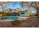 This home features a refreshing in-ground pool, patio, and screened-in lanai in a tree-lined backyard at 1710 Orange Hill Way, Brandon, FL 33510