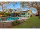 Beautiful backyard featuring a sparkling swimming pool and a screened-in porch at 1710 Orange Hill Way, Brandon, FL 33510