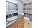 Stylish bathroom featuring a vanity with a dark countertop and patterned shower curtain at 1710 Orange Hill Way, Brandon, FL 33510