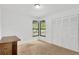 Bedroom with a corner window, a closet, neutral carpet, and a wooden dresser at 1710 Orange Hill Way, Brandon, FL 33510