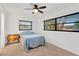 Bright bedroom with two windows, a ceiling fan, and a warm-toned antique end table at 1710 Orange Hill Way, Brandon, FL 33510