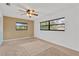 Bedroom featuring two windows, neutral carpet, and light-colored walls at 1710 Orange Hill Way, Brandon, FL 33510