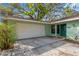 Exterior view of the home with a two-car garage, well-kept lawn, and charming front door at 1710 Orange Hill Way, Brandon, FL 33510