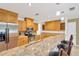 Kitchen with oak cabinets, granite counters, stainless appliances and breakfast bar with seating at 1710 Orange Hill Way, Brandon, FL 33510