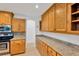 Kitchen featuring granite countertops, oak cabinets and stainless steel appliances at 1710 Orange Hill Way, Brandon, FL 33510