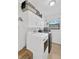Laundry room with washer, dryer, storage cabinets and tile flooring at 1710 Orange Hill Way, Brandon, FL 33510