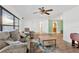 Open-concept living room with wood floors, bright white walls, ceiling fan, and comfortable seating at 1710 Orange Hill Way, Brandon, FL 33510